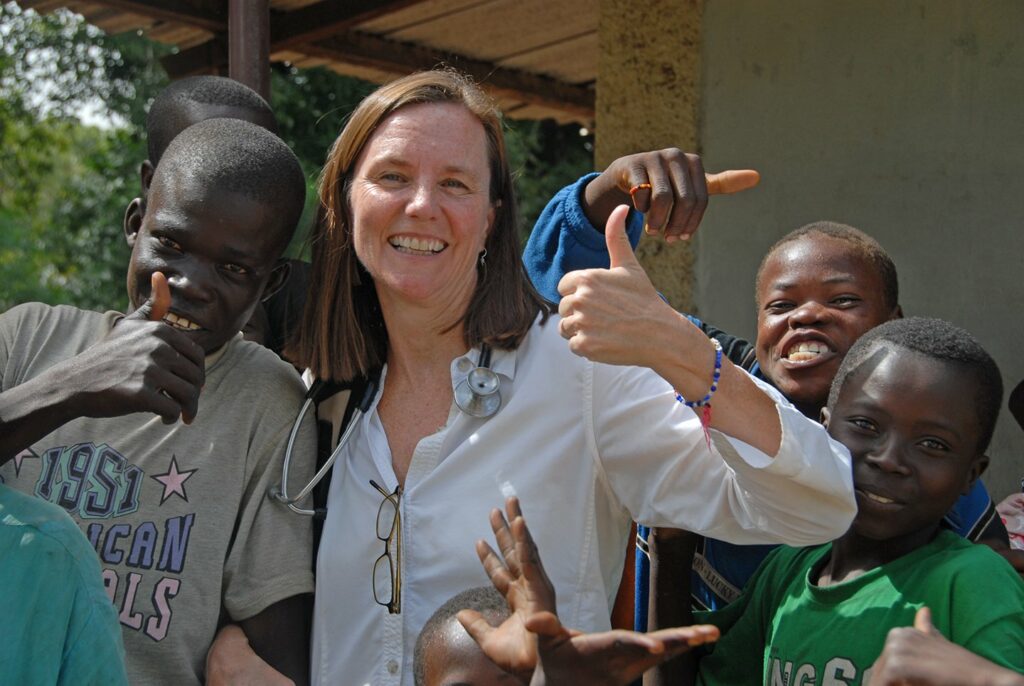 Woman standing with children smiling